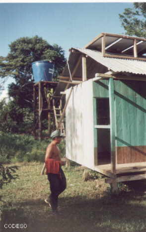 Installation in Yamaram Suku, man sieht die Paneele auf dem Dach und den Verteilertank im Hintergrund
